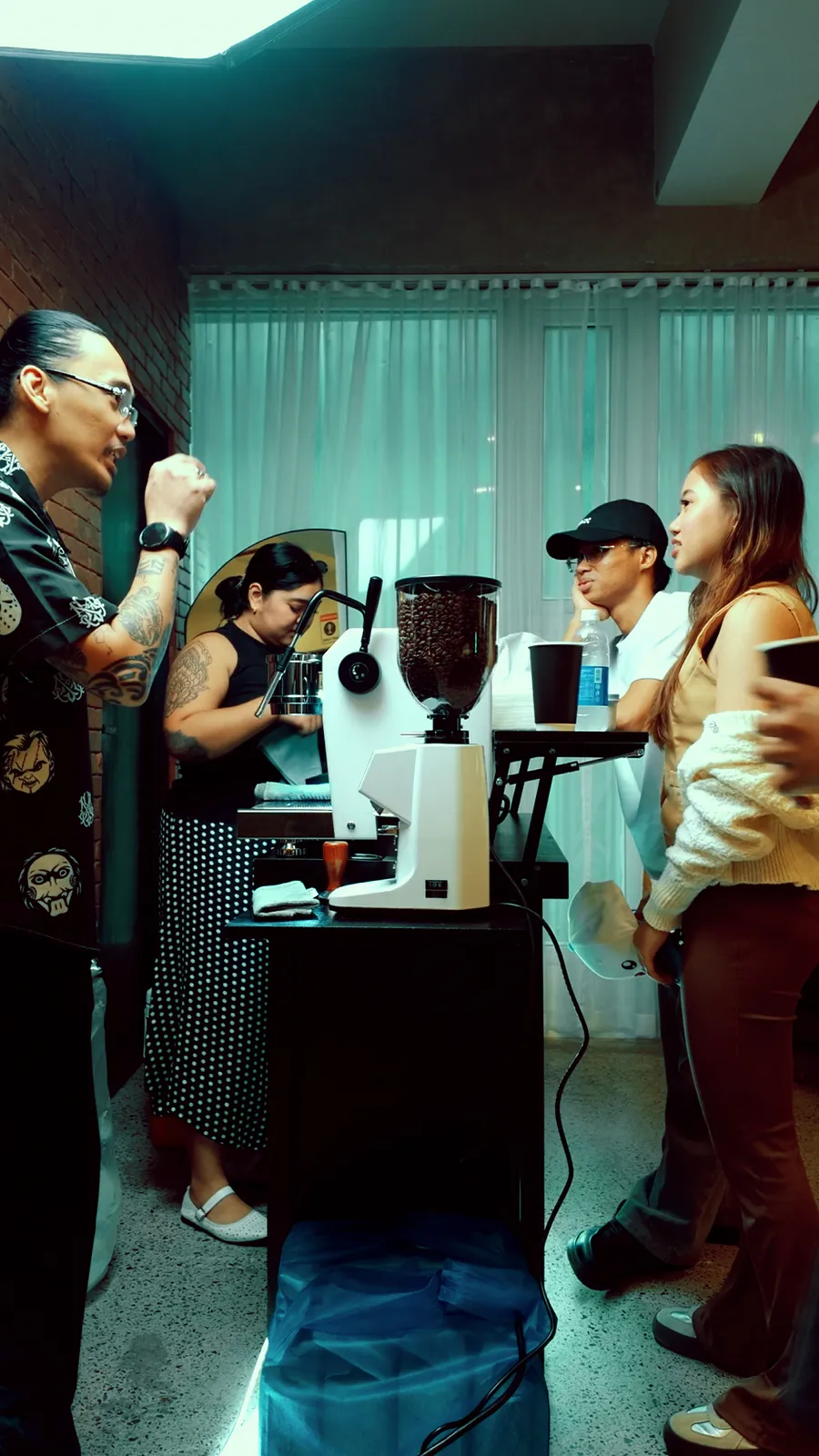 The GN Commune cart at work: a barista at the espresso machine while guests chat at the counter.